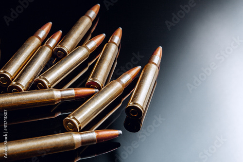 Wallpaper Mural Rifle bullets or cartridges on black shiny background