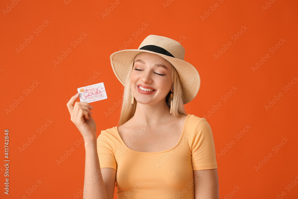 Beautiful young woman with gift card on color background Beautiful young woman with gift card on color background