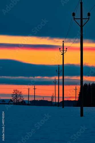 orange sunset and power line in field
