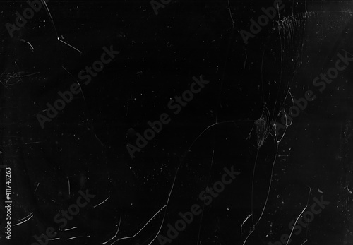 Fractured overlay. Broken screen. Dark smashed shattered laptop glass with dust scratches stains grain noise grunge effect mask.