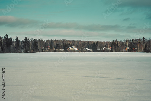 Winter rural landscape in Russia on the background of the forest.
