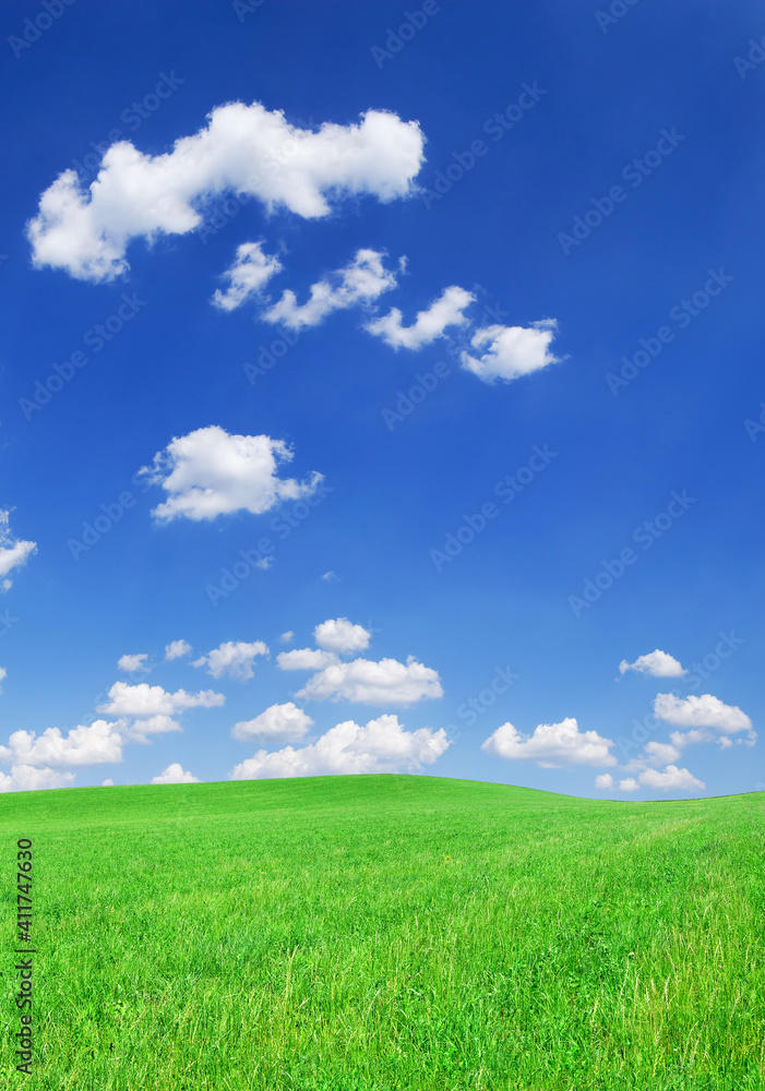 Idyllic view, green hills and blue sky with white clouds