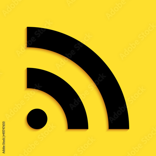 Black RSS icon isolated on yellow background. Radio signal. RSS feed symbol. Long shadow style. Vector.