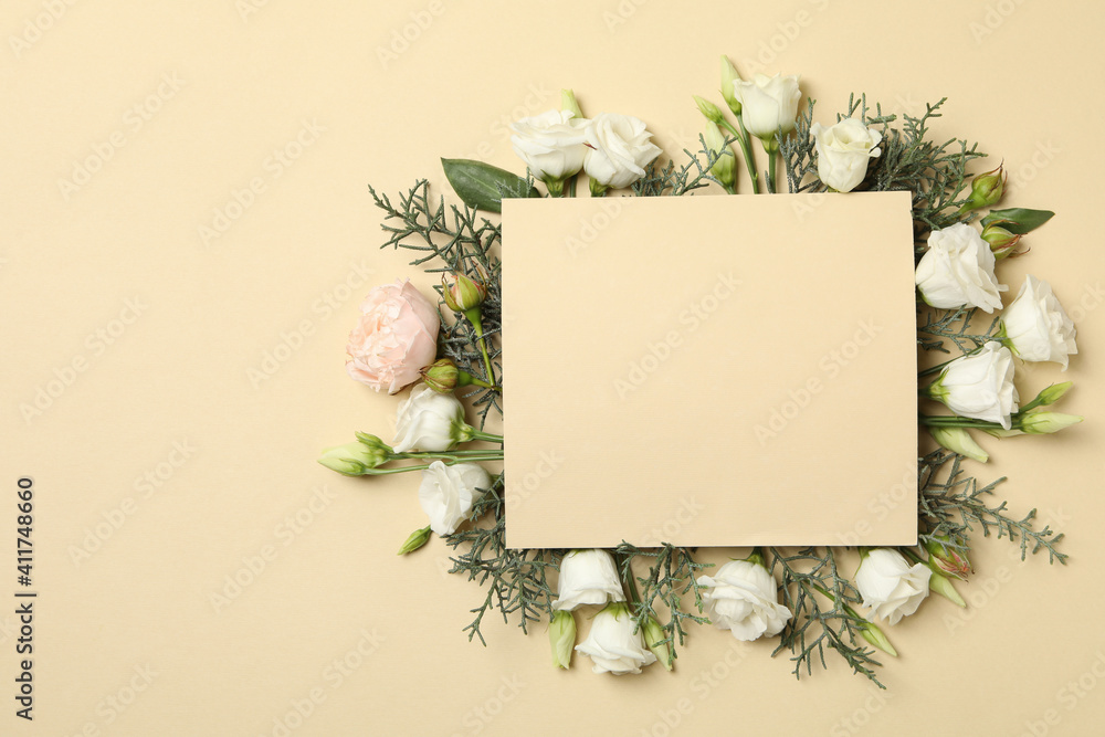 Roses, thuja branches and space for text on beige background