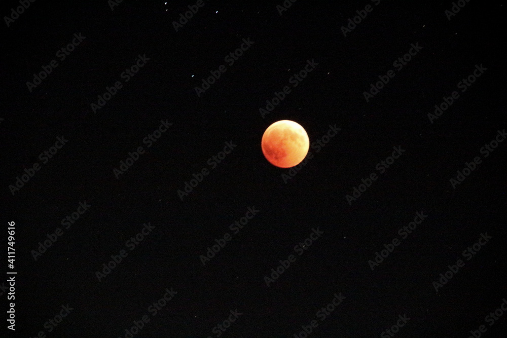 evocative image of moon eclipse at night up in the sky
