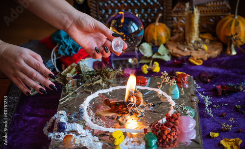 Candle burns a herb on the altar, magic among candles, clean negative energy, wicca  concept photo
