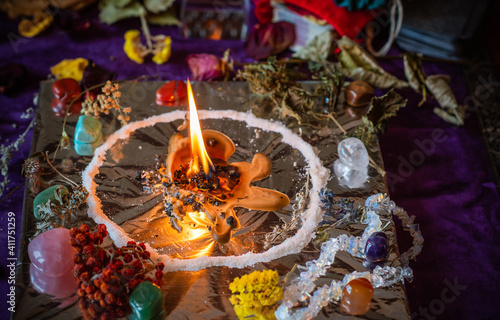 Candle burns a herb on the altar  magic among candles  clean negative energy  wicca  concept