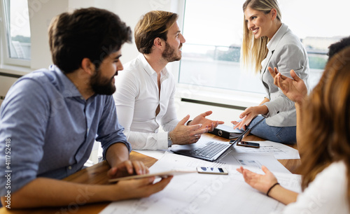 Cheerful coworkers in office during company meeting