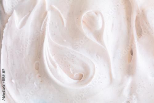 Fototapeta Creamy texture of white airy scrub foam with peeling particle