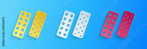 Paper cut Pills or capsules in blister package icon isolated on blue background. Tablets in package. Medications Accessory pharmacies and first aid kits. Paper art style. Vector.