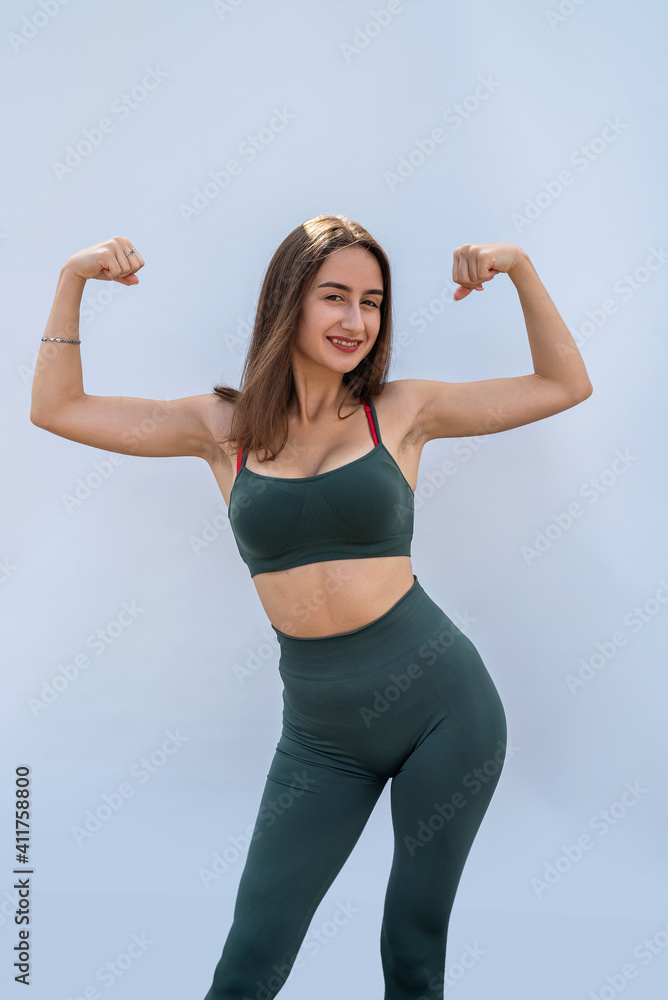 portrait of fitness woman in sportswear posing isolated on gray background portrait of fitness woman in sportswear posing isolated on gray background
