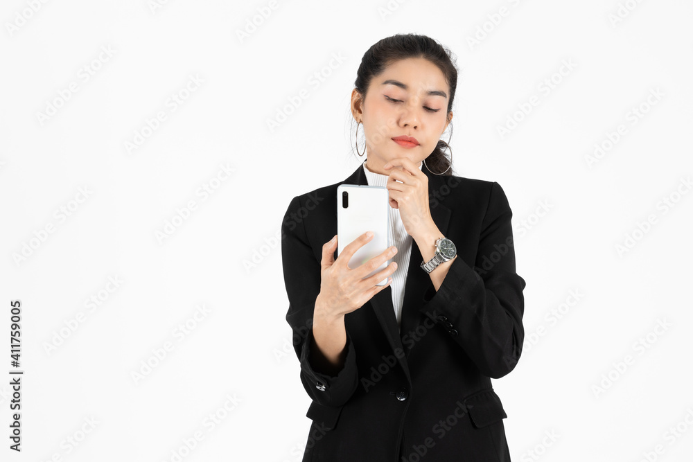 Young Asian business woman in suit holding mobile smart phone over white isolated background. Young Asian business woman in suit holding mobile smart phone over white isolated background.