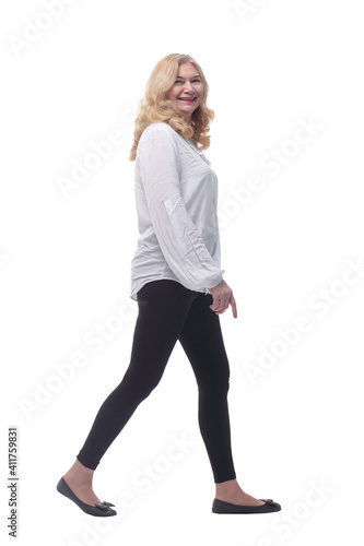 side view. woman in comfortable clothing striding forward .