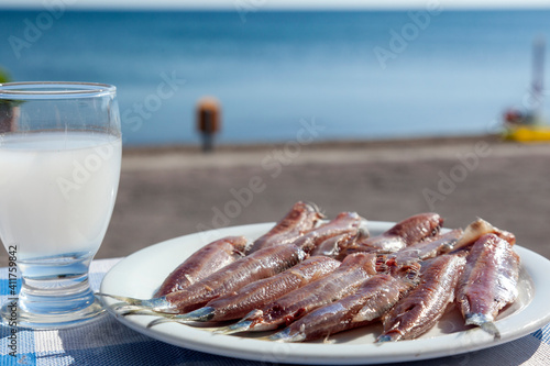 Salted sardines and ouzo drink, a popular fishery delicacy of Kalloni, Lesvos island, Greece, which is now recognised as Product of Protected Designation of Origin from the European Union.  photo