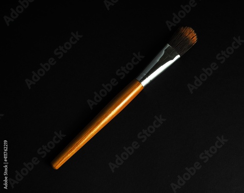 single wooden treucco brush on on black table