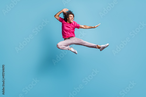 Full length body size view of attractive cheerful crazy motivated guy jumping dancing ballet isolated over bright blue color background