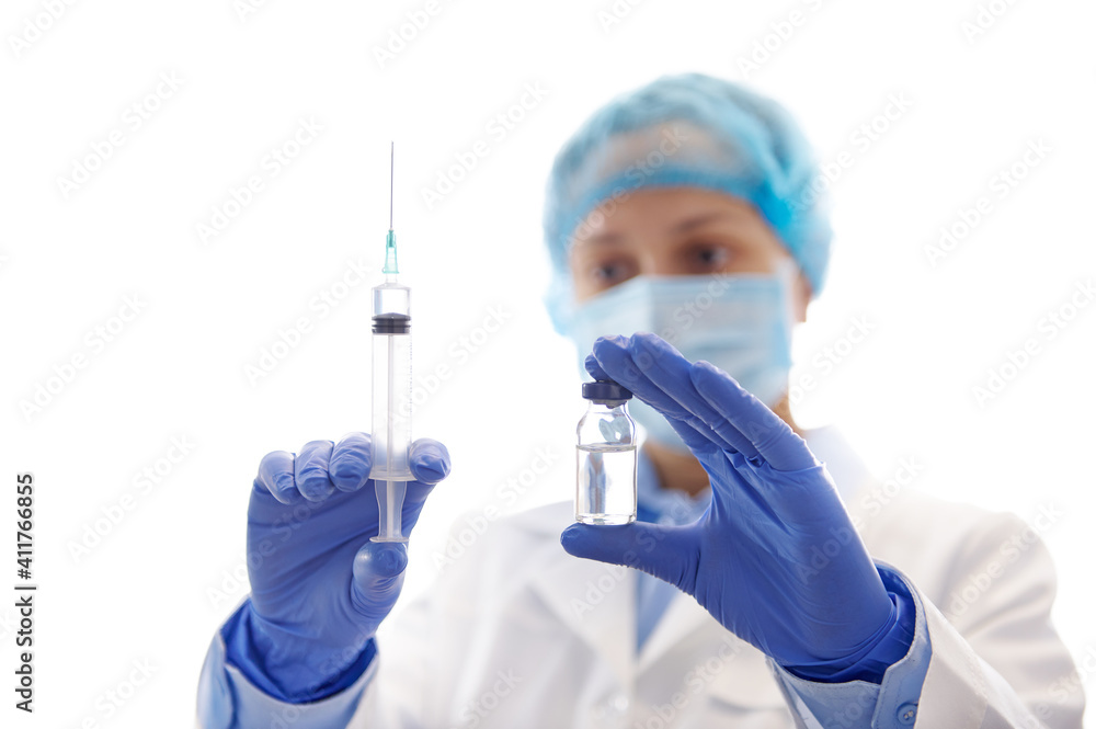 Doctor preparing vaccine. Syringe and vaccine against the background of a doctor in workwear. Immunization of the population. Doctor preparing vaccine. Syringe and vaccine against the background of a doctor in workwear. Immunization of the population.