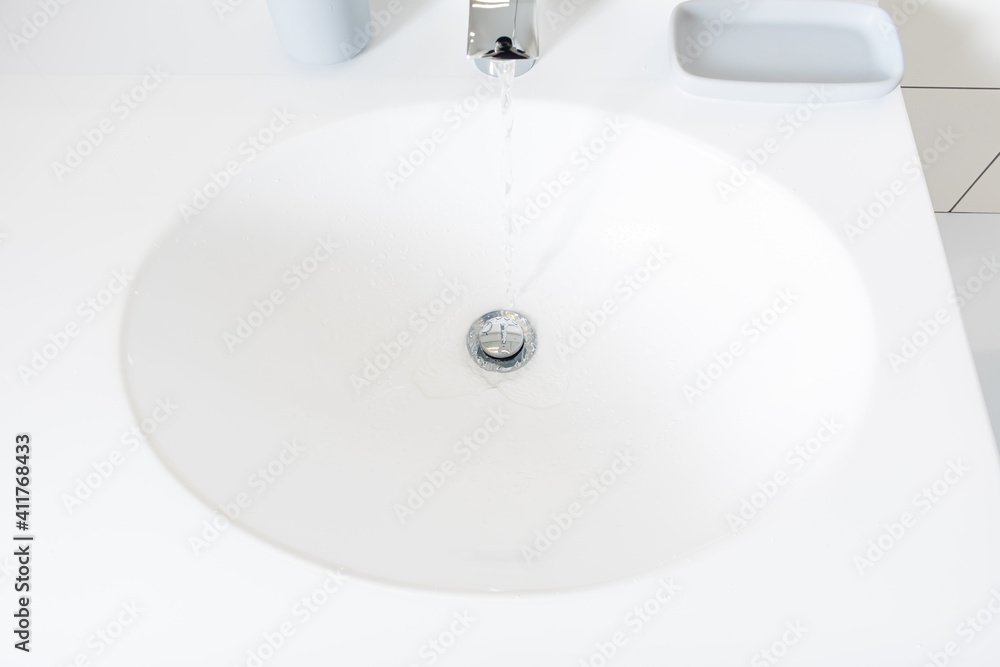 Modern bathroom detail in a luxury home, white sink and chrome tap Modern bathroom detail in a luxury home, white sink and chrome tap
