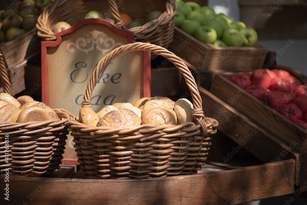 Basket full of fresh baked bread and vegetables on the market Basket full of fresh baked bread and vegetables on the market