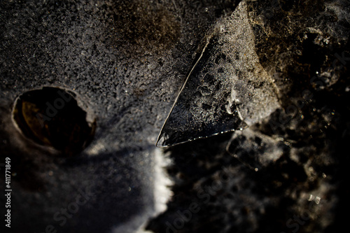 nteresting abstract background with ice close-up on a frozen puddle photo