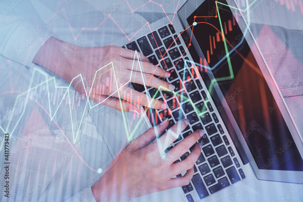 Double exposure of woman hands working on computer and forex chart hologram drawing. Top View. Financial analysis concept. Double exposure of woman hands working on computer and forex chart hologram drawing. Top View. Financial analysis concept.
