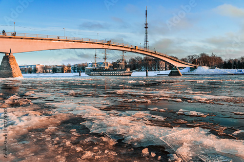 Pedestrian bridge over the Volkhov River. Winter view of a frozen river. Veliky Novgorod, Russia