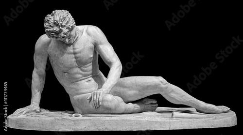 Ancient white marble sculpture of naked dying man Gaul. Antique classic statue of soldier isolated on black. Stone wounded male figure