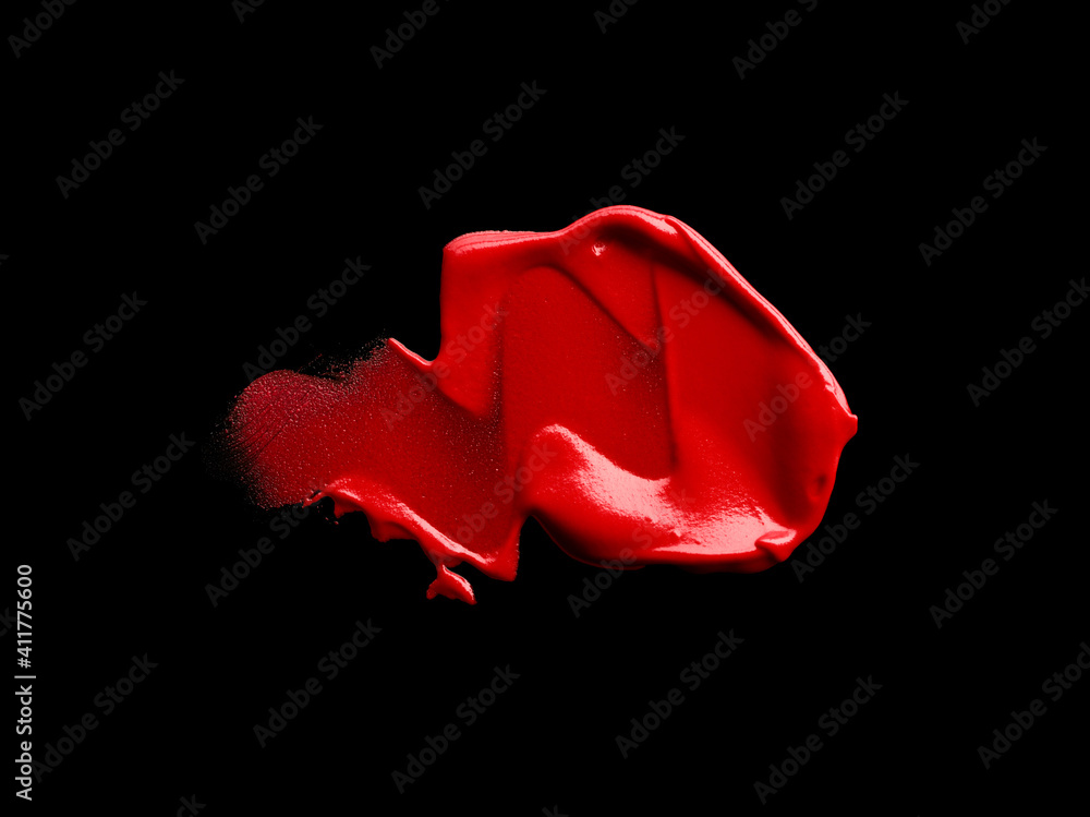 Fototapeta premium Smudged red lipstick isolated on black background