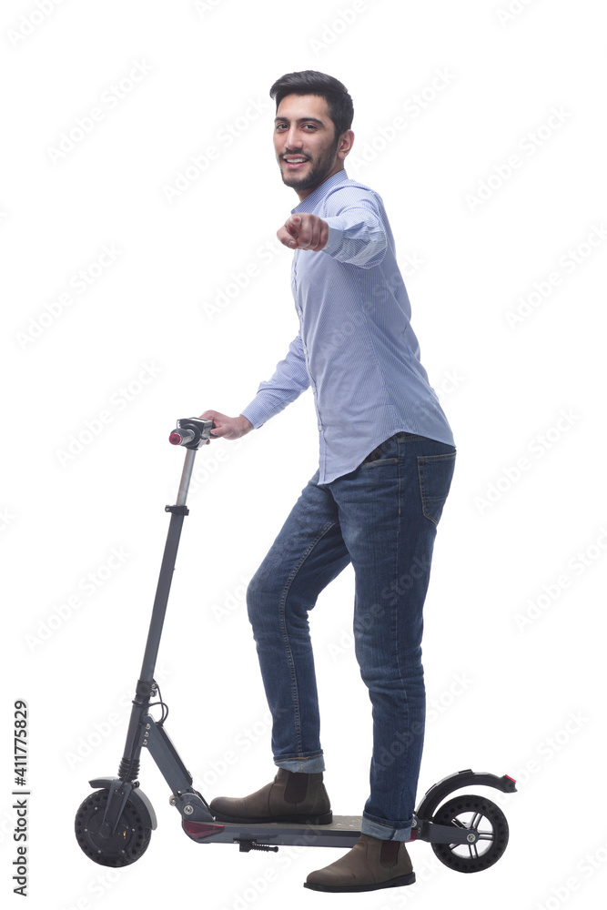 side view. attractive young man with an electric scooter. side view. attractive young man with an electric scooter.
