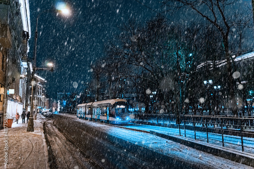 Canvas Print Modern moscow tram running through the snow