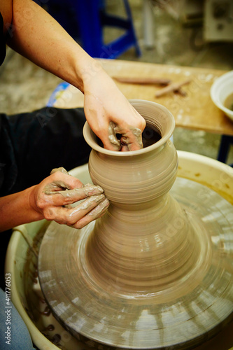 working with clay on potter's wheel
