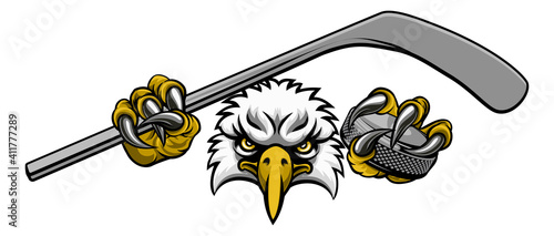 An eagle ice hockey player animal sports mascot holding a hockey stick and puck