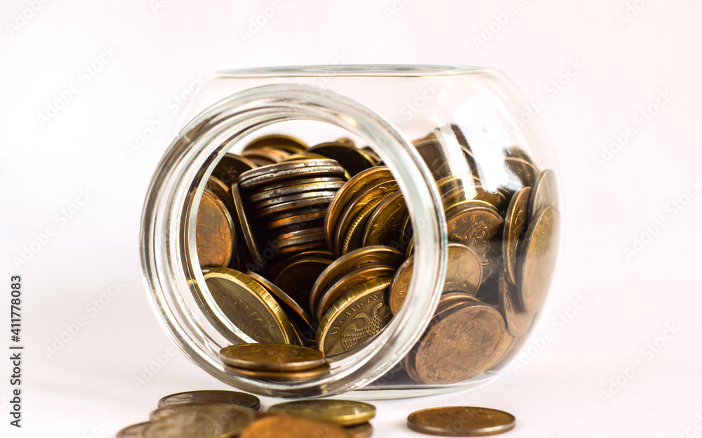 Metal coins in a glass jar. Keeping personal savings. Financial crisis, ruble devaluation. Copy space. Selective focus. Metal coins in a glass jar. Keeping personal savings. Financial crisis, ruble devaluation. Copy space. Selective focus.