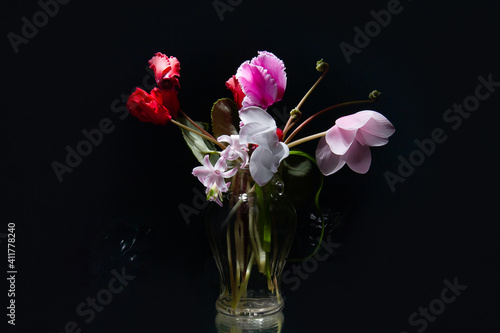 А bouquet of flowers in a vase on a rough background! Delicate spring flowers.