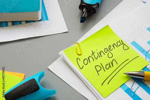 Photos Business Contingency plan papers and notepad on the table.