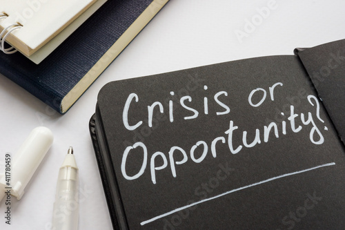 Crisis or opportunity question on the black page. photo