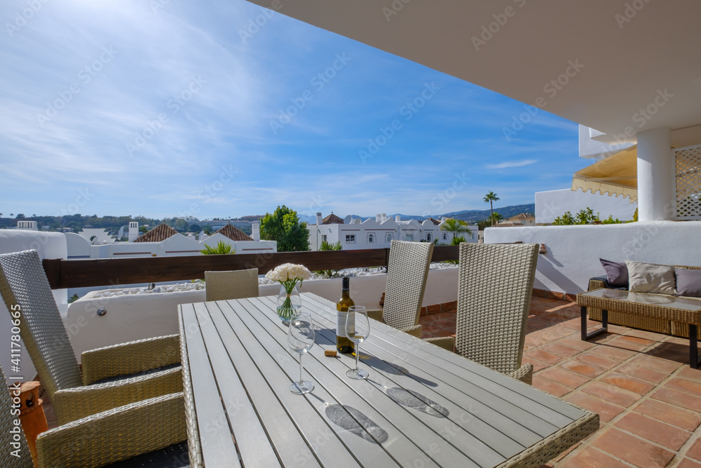 empty wooden table and chairs on the terrace in summer empty wooden table and chairs on the terrace in summer