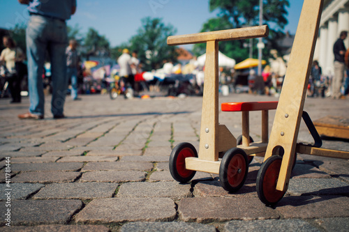 close up of wooden children scooters on cobblestone
