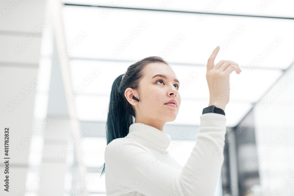 Asian girl touching virtual screen futuristic technology