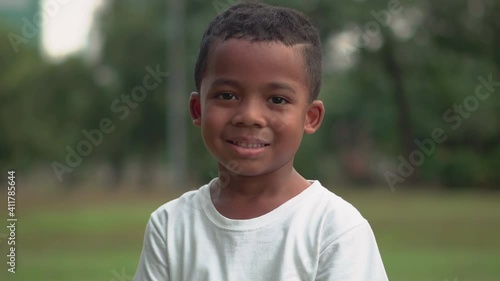 Portrait of happy african american kids boy playing outdoors in a park, Kid playing concept.