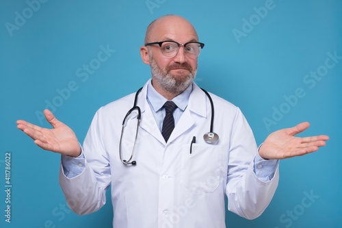 Картината върху платно Experienced male doctor standing with open arms asking so how