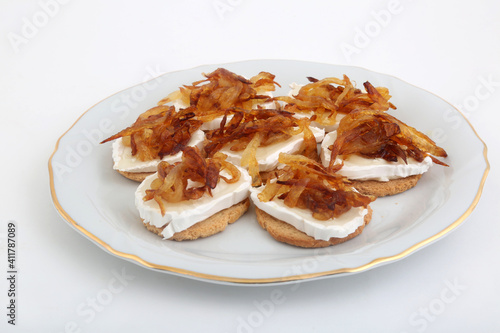 Mozzarella and fried onion toast canape as appetizer