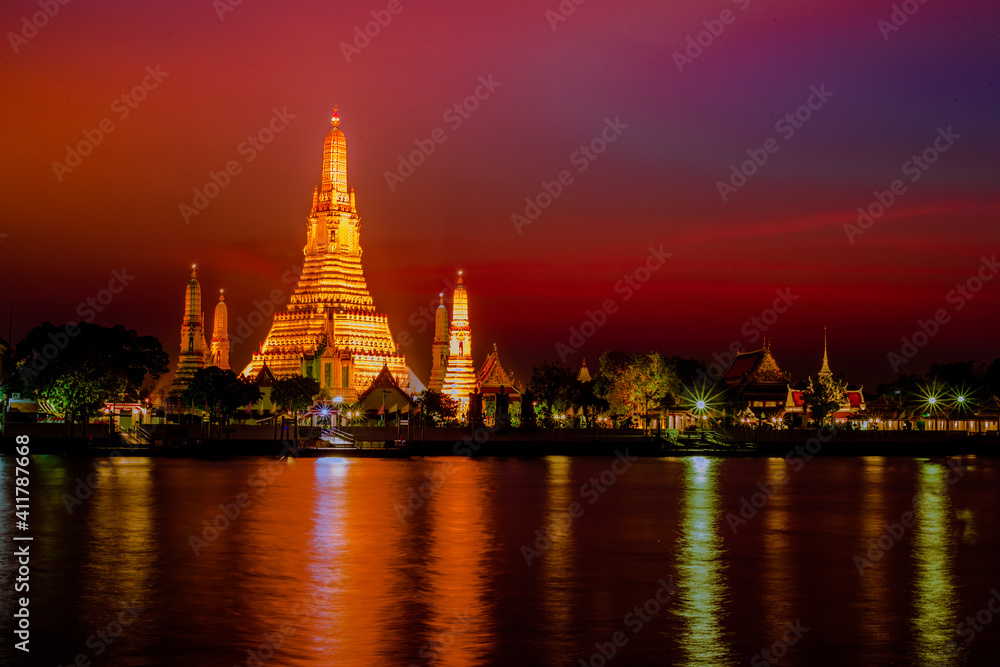 A close-up view of the background of a major tourist attraction in Bangkok of Thailand (Wat Arun Ratchawararam Ratchaworamahawihan) is a large chedi installed on the Chao Phraya River.