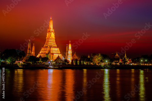 A close-up view of the background of a major tourist attraction in Bangkok of Thailand (Wat Arun Ratchawararam Ratchaworamahawihan) is a large chedi installed on the Chao Phraya River. © bangprik