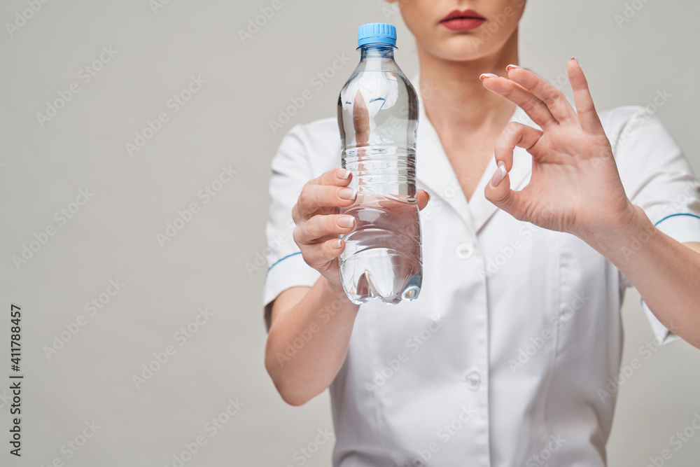female woman nutritionist or dietician doctor healthy lifestyle concept - holding bottle of water female woman nutritionist or dietician doctor healthy lifestyle concept - holding bottle of water