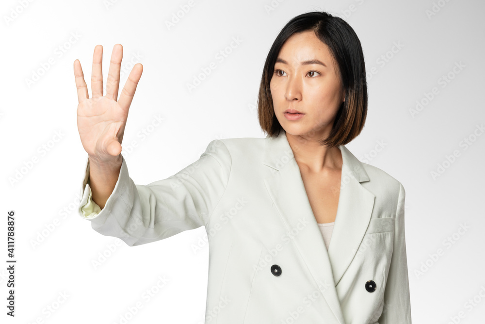 Asian businesswoman touching virtual screen Asian businesswoman touching virtual screen