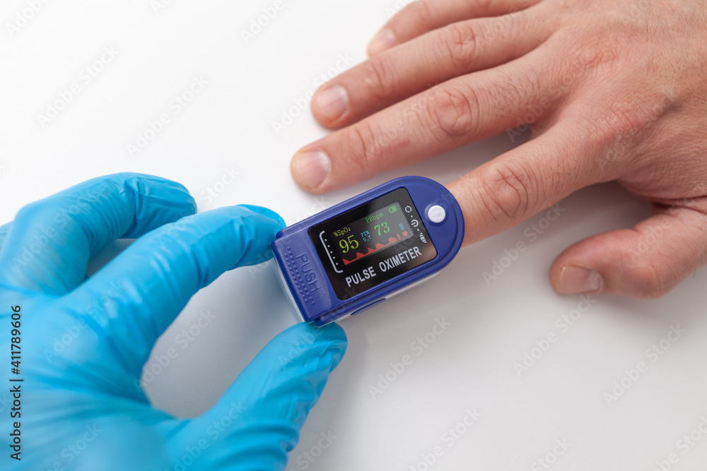 Doctor using pulse oximeter to check patient oxygen saturation Doctor using pulse oximeter to check patient oxygen saturation