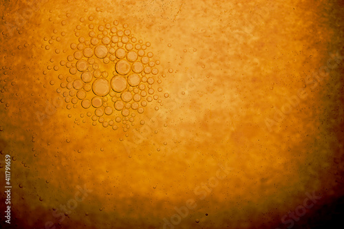 Abstract background of small bubbles group floating in yellow grunge liquid with copy space. Group of bubbles is in camera focus
