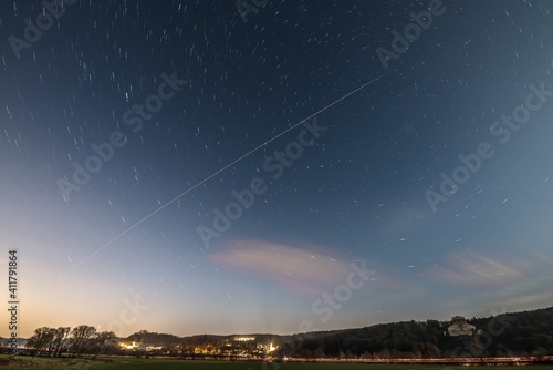 Langzeitaufnahme der Internationalen Raumstation ISS während Sonnenuntergang in Bayern mit Walhalla bei Regensburg im Hintergrund, Deutschland photo