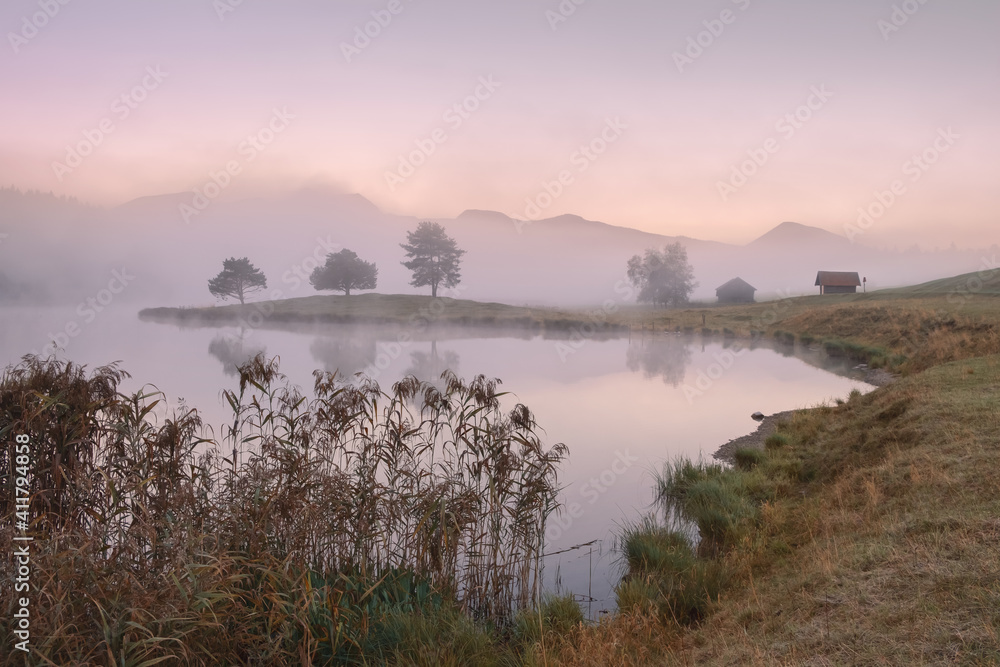 Autumn morning landscape with fog over the lake.